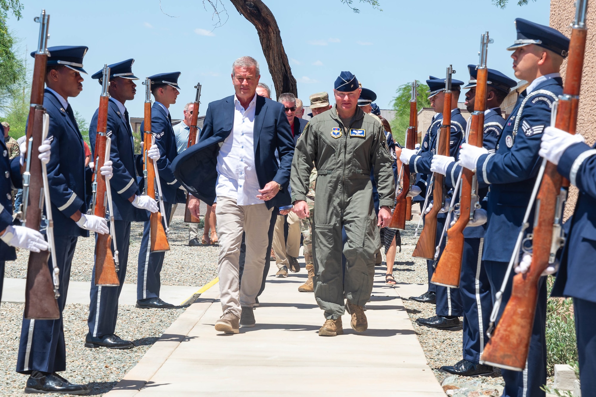 U.S. Air Force Brig. Gen. David Berkland, 56th Fighter Wing commander, right, and Jeff Gordon, CEO of IDM companies, walk through a cordon during a ribbon cutting ceremony held for the new Honor Guard facility at Luke Air Force Base, Arizona, May 7, 2026.