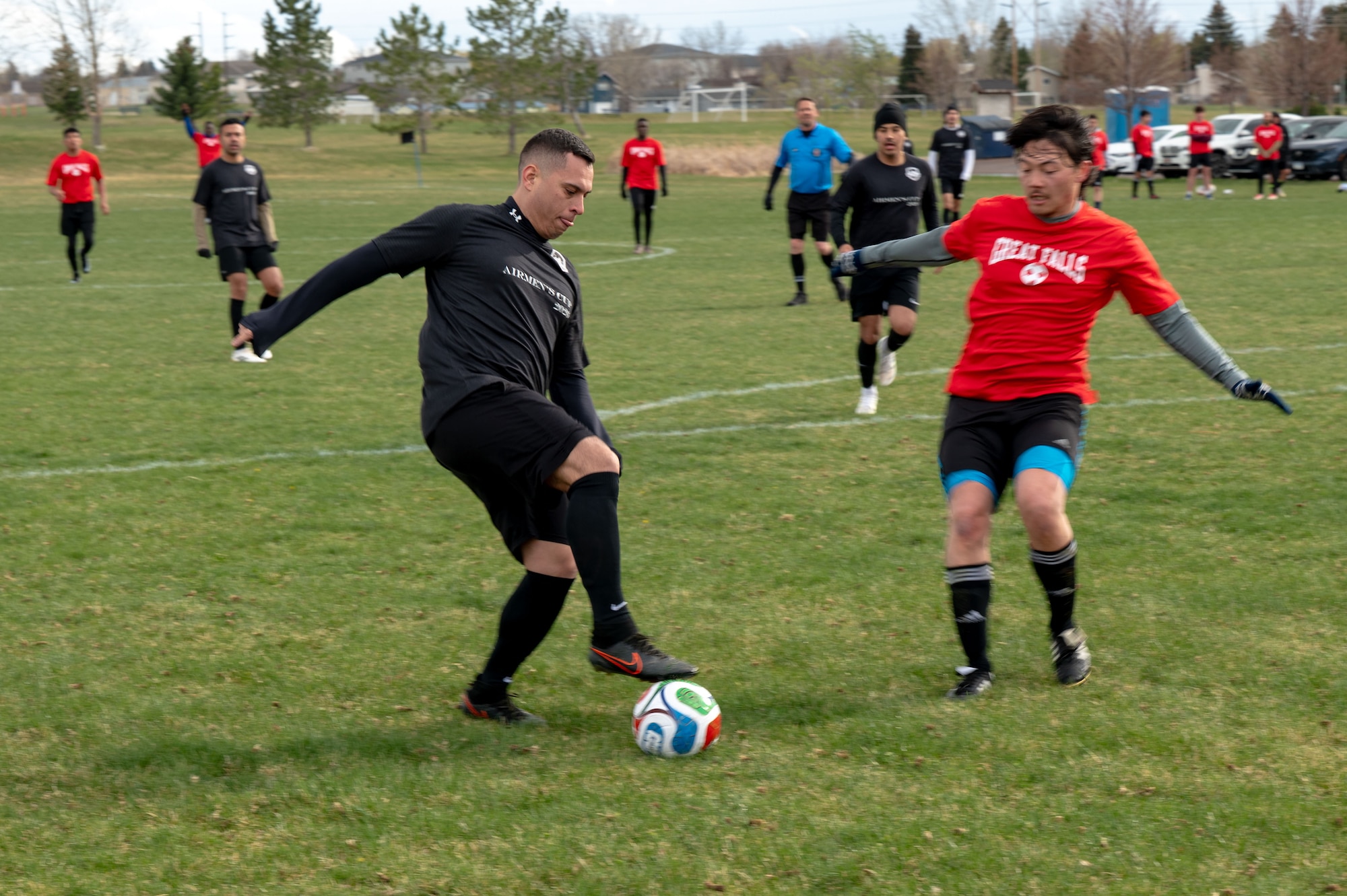 Nuke FC player handling soccer ball with foot and keeping it from Great Falls player.