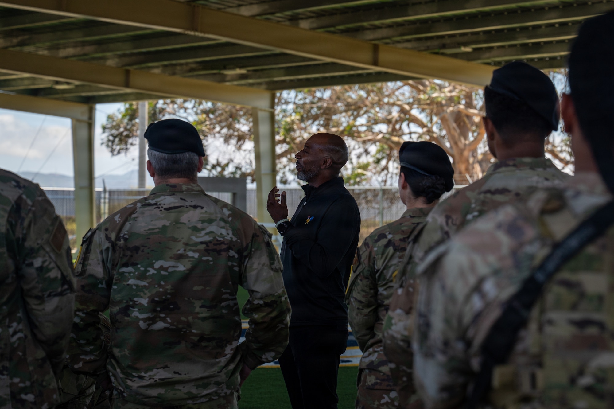 Kaleth O. Wright speaks and gestures toward a crowd of military members.