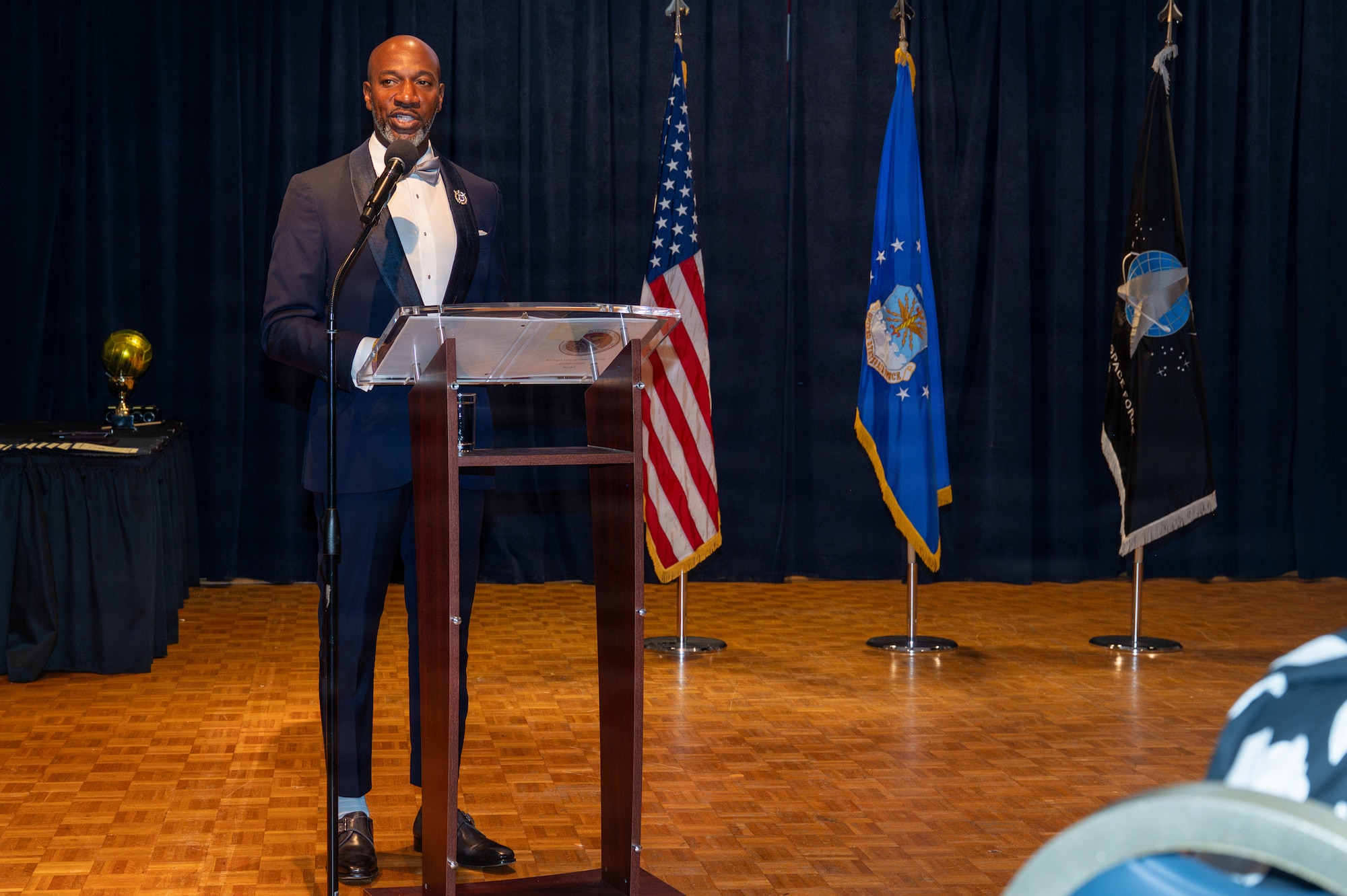 Kaleth O. Wright stands behind a podium and speaks.