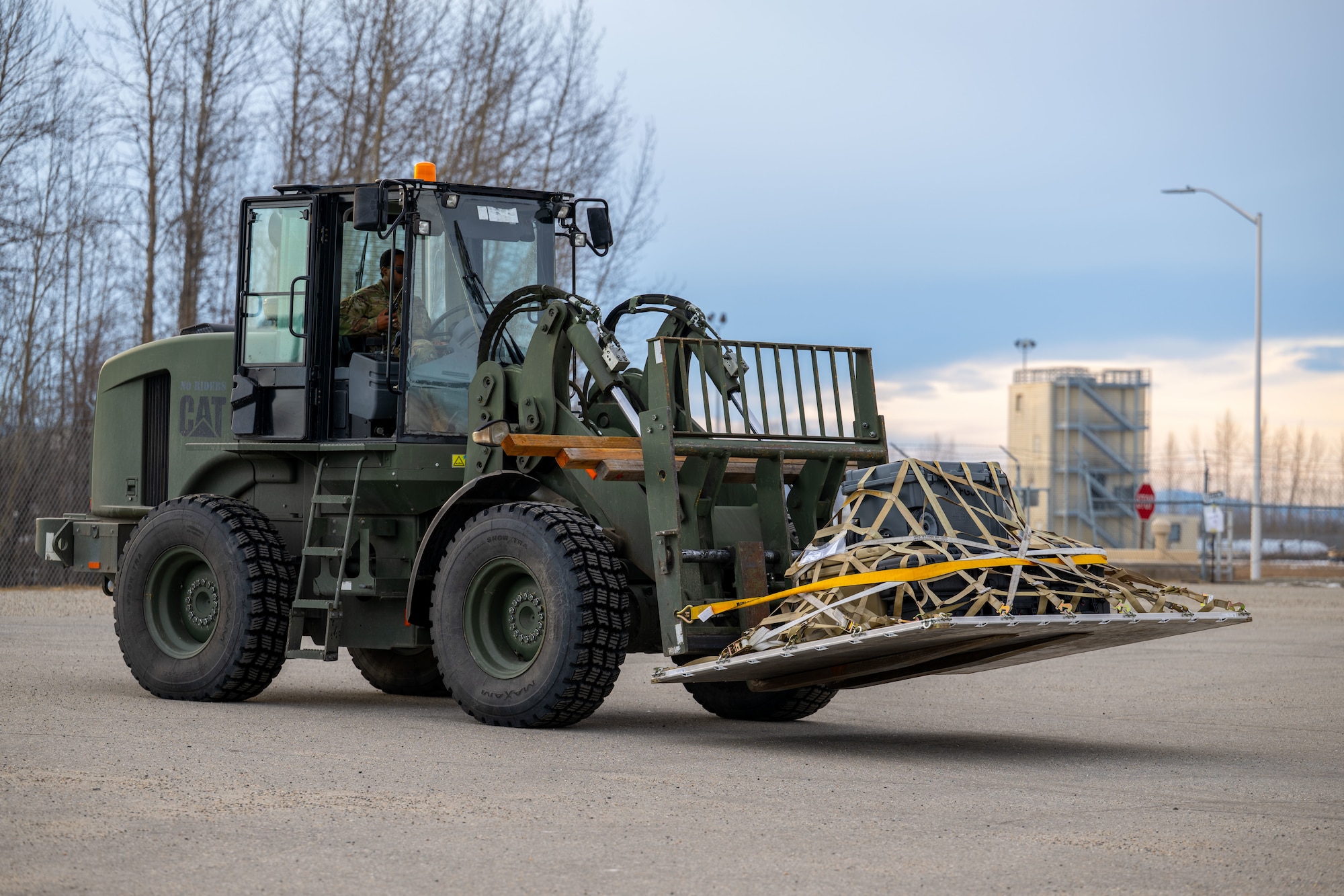 Airman 1st Class Dante Thomas, 354th Logistics Readiness Squadron ground transportation operator, transports cargo with a 10K All-Terrain Forklift.