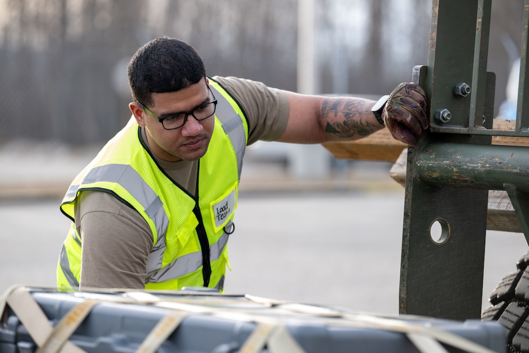 Senior Airman Angel Rodriguez-Martinez, 354th Logistics Readiness Squadron vehicle management journeyman, inspects cargo supplies.