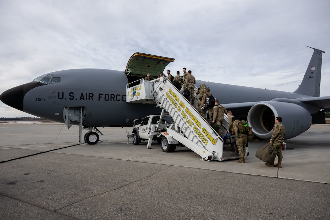 Airmen from the 354th Fighter Wing board a KC-135 Stratotanker assigned to the 168th Wing, Air National Guard.