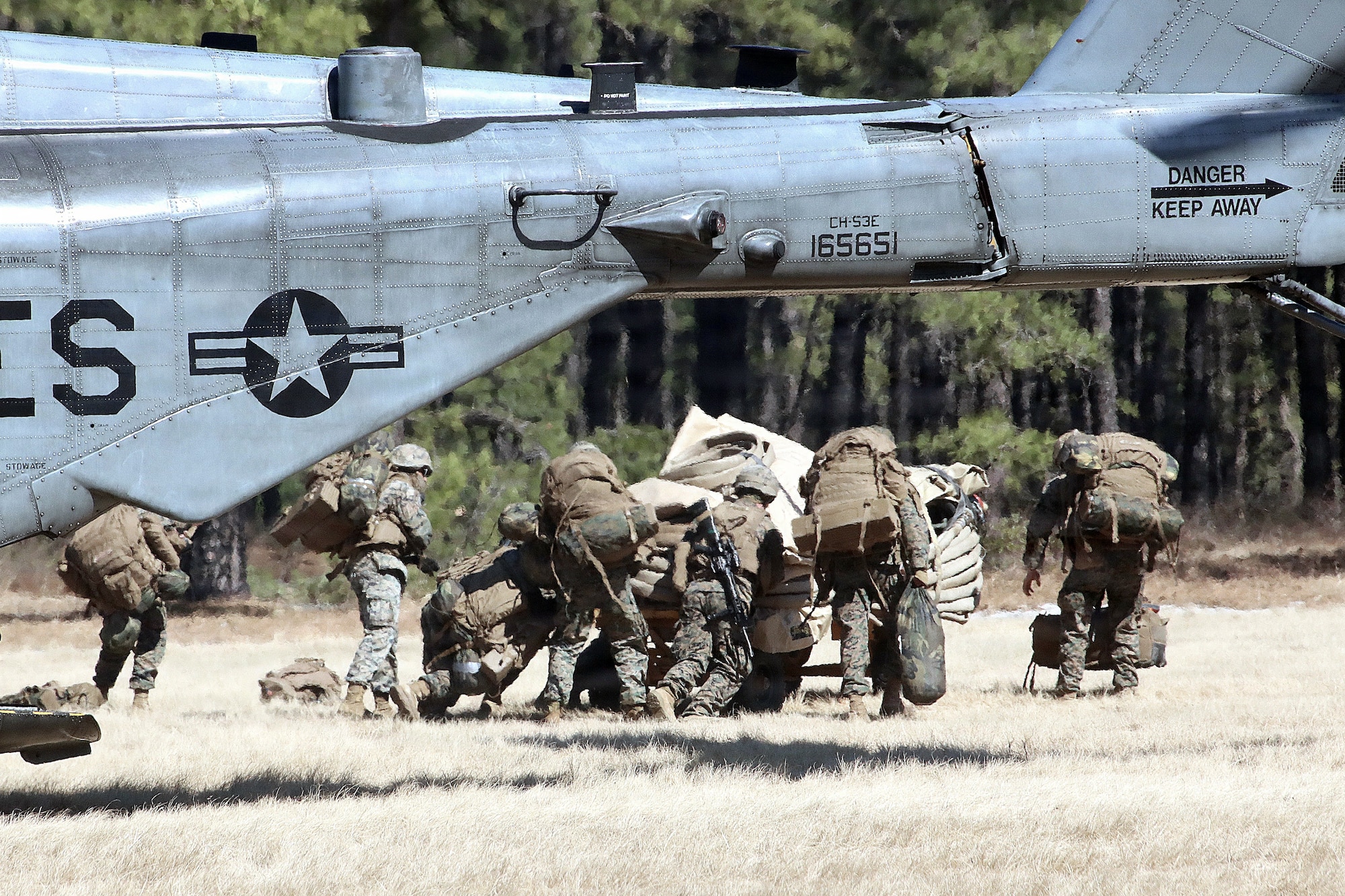 U.S. Marine Corps Reserve Marines assigned to the Marine Wing Support Squadron 472 work together to unload their equipment from a CH-53 helicopter to set up and operate a forward arming and refueling point during a combined arms live-fire exercise at Joint Base McGuire-Dix-Lakehurst, N.J., March 22, 2026. The FARP training familiarized Marines with the procedures for refueling aircraft in field environments. The CALFEX, led by 2nd Battalion, 25th Marines Regiment, integrated forces from Marine Forces Reserve units based in New Jersey and operating out of JB MDL to conduct aviation and ground operations throughout the exercise, linking logistics, fires and maneuver elements in a continuous training scenario. (U.S. Army photo by Steven Roussel)