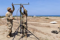 U.S. Army Pfc. Saul Aidaria, left, and Sgt. Jonathan Hillman, both signal support system specialist assigned to 25th Infantry Division Artillery, establishes signal connectivity during Exercise Balikatan 2026 at La Paz Sand Dunes, Laoag City, Philippines, May 1, 2026.