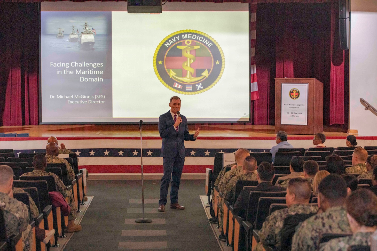 260504-N-KC192-1010 PORTSMOUTH, Va. (May 4, 2026) Dr. Michael McGinnis, Bureau of Medicine and Surgery (BUMED) executive director, gives opening remarks during the 2026 Medical Logistics Symposium held on board Naval Medical Center Portsmouth, May 4, 2026. The Navy Medicine Logistics Symposium aims to maintain a common operating picture and update the Medical Logistics community regarding the fiscal year 2026 Navy Medicine Campaign Order and the Navy MEDLOG goal to build a logistics system that delivers ready operational units to support the Naval Strategy. (U.S. Navy photo by Mass Communication Specialist Second Class Levi Decker)