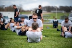 U.S. Air Force Airmen practice sit-ups and core strength exercises during a unit physical training session at Wright-Patterson Air Force Base, Ohio, April 2, 2026. Airmen participated in a fitness assessment designed to improve their physical performance and readiness. (U.S. Air Force photo by Daniel Peterson)