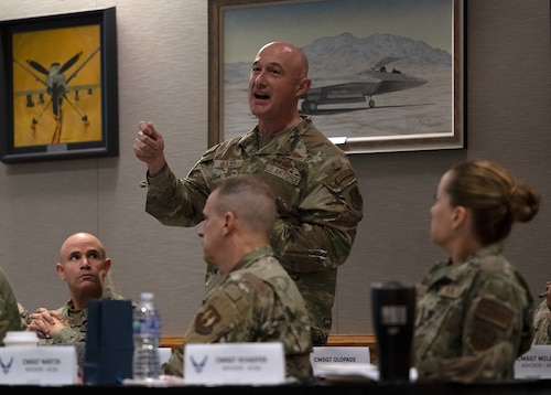 A bald Airman stands up and makes remarks.
