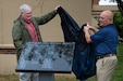 Retired Brig. Gen. David Mounkes, left, former assistant adjutant general for Air in the Kentucky National Guard, and retired Master Sgt. Chris Tells, former senior enlisted leader for the 123rd Contingency Response Group, unveil a plaque containing the names of 53 2025 retirees during a ceremony at the Kentucky Air National Guard Base in Louisville, Ky., April 18, 2026. The plaque honors Airmen who completed at least 20 years of military service at the Kentucky Air Guard last year. (U.S. Air National Guard photo by Airman 1st Class Angelee Barnett)