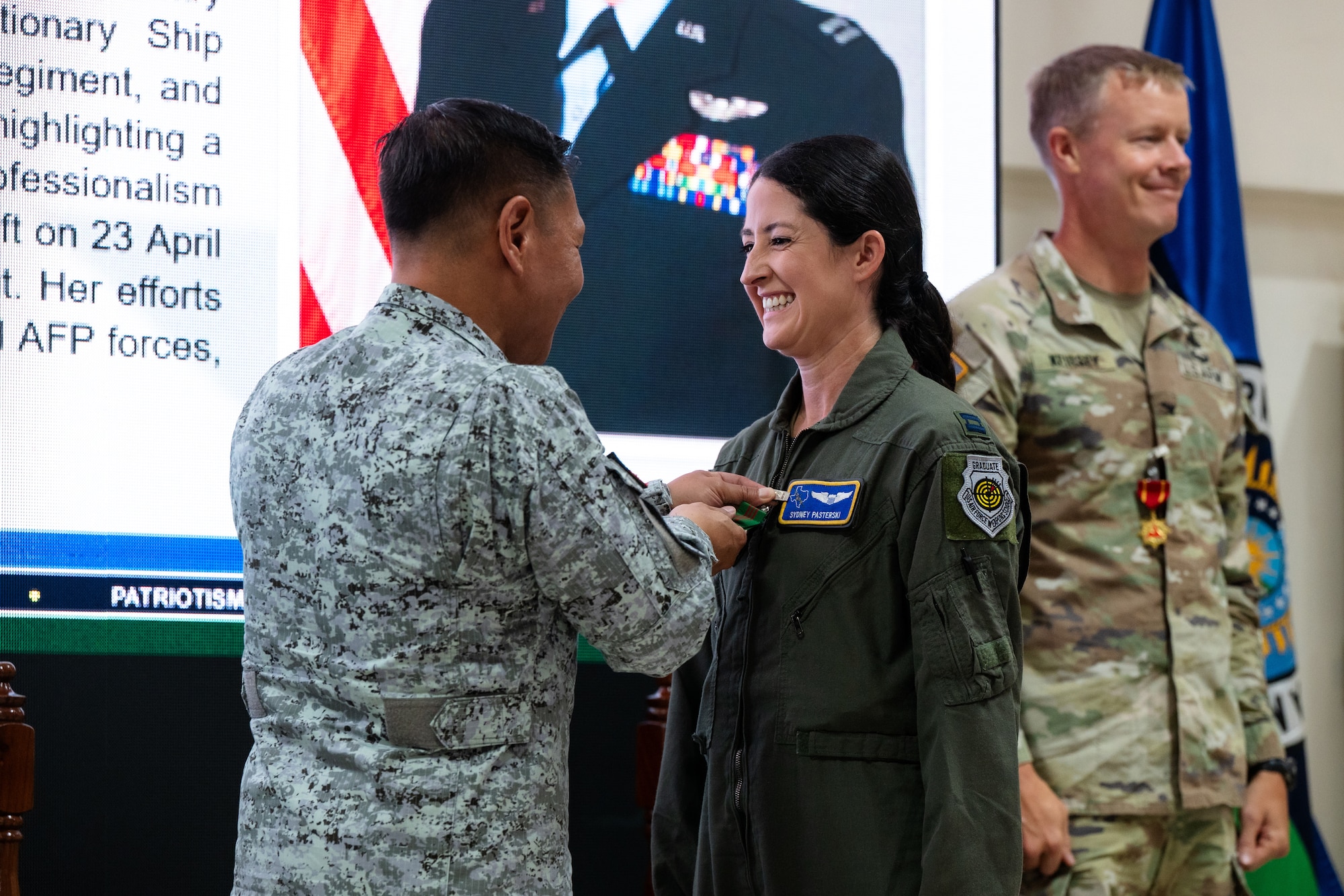 Philippine Air Force Lt. Gen. Aristotle Gonzalez, left, commander of Northern Luzon Command, pins the Armed Forces of the Philippines Military Merit Medal on U.S. Air Force Capt. Sydney Pasterski, a pilot assigned to the 40th Airlift Squadron, and mission commander for Balikatan 2026, for her service in support of Exercise Balikatan 2026 at Camp General Servillano A. Aquino, Philippines, May 5, 2026. Balikatan is a longstanding annual exercise between the Armed Forces of the Philippines and U.S. military that represents the strength of our alliance, improves our capable combined force, and demonstrates our commitment to regional peace and prosperity. (U.S. Air Force photo by Senior Airman Jade M. Caldwell)