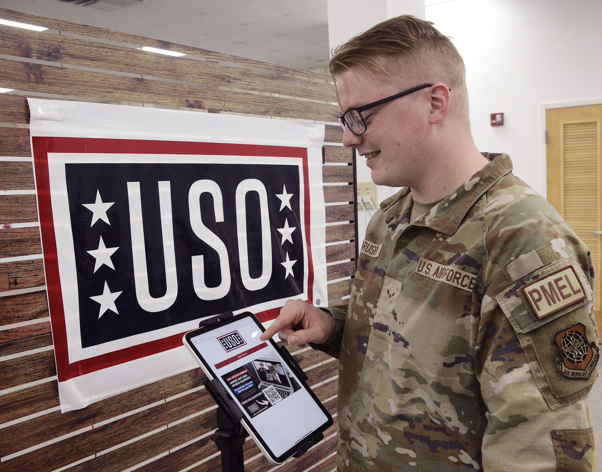 U.S. Air Force Airman 1st Class Trevor Marusek, 305th Maintenance Squadron precision measurement equipment laboratory journeyman, signs in at the new USO center at Joint Base McGuire-Dix-Lakehurst, N.J., April, 20, 2026. The 6,600-square-foot center features Wi-fi, computers, gaming systems, televisions, pool tables and enhanced lounge areas with refreshments, all at no cost to active duty, Reserve and National Guard service members, retirees and their dependents with valid identification. (U.S. Air Force photo by Kris Patterson)