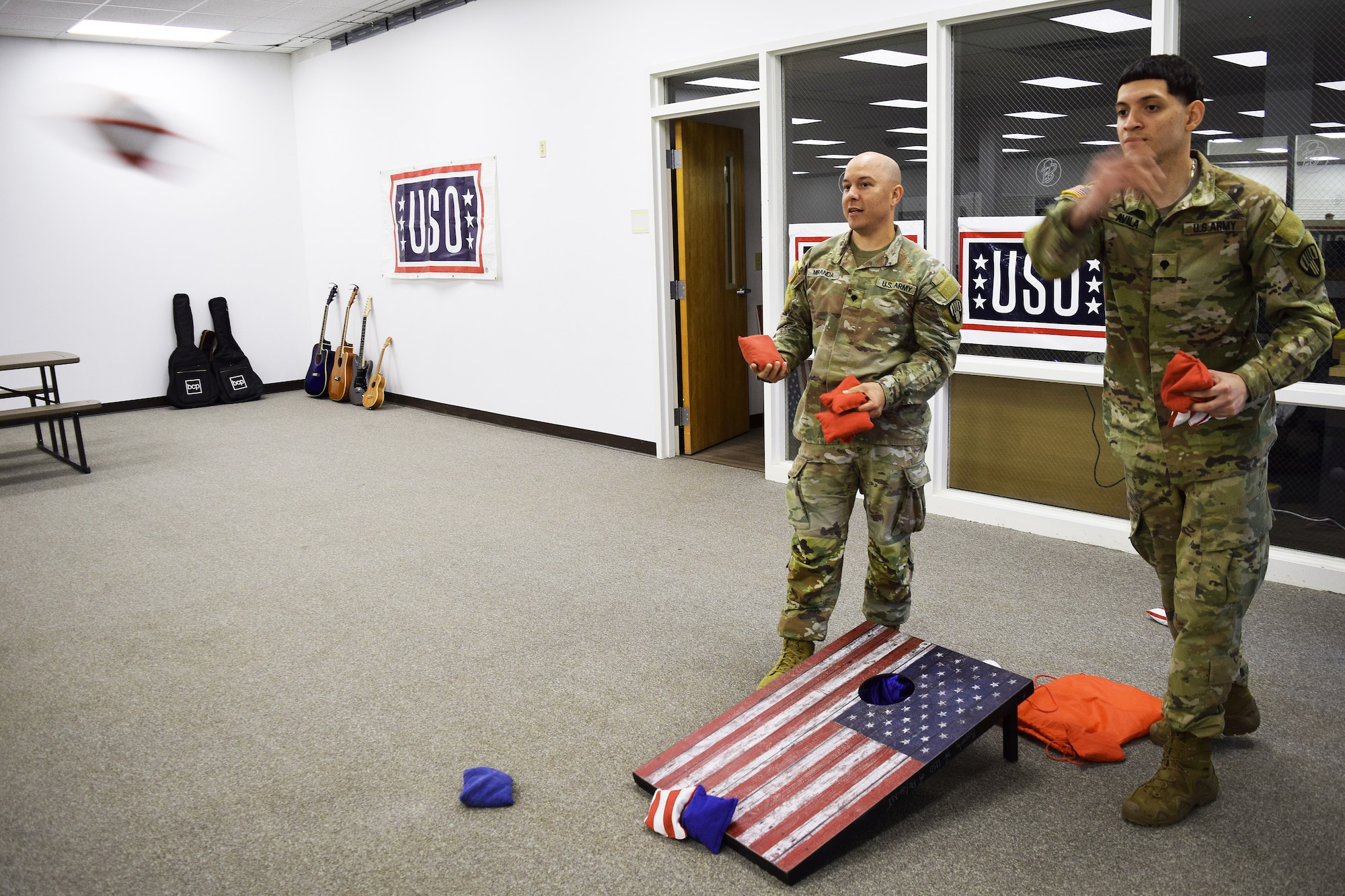 U.S. Army National Guard Soldiers assigned to the New York Army National Guard play cornhole inside the new USO center at Joint Base McGuire-Dix-Lakehurst, N.J., April, 23, 2026. The 6,600-square-foot center features Wi-fi, computers, gaming systems, televisions, pool tables and enhanced lounge areas with refreshments, all at no cost to active duty, Reserve and National Guard service members, retirees and their dependents with valid identification. (U.S. Air Force photo by Kris Patterson)