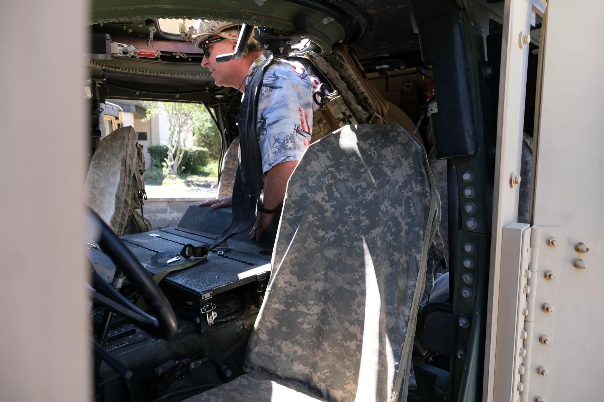 photo of civic leader cllimbing into a Humvee