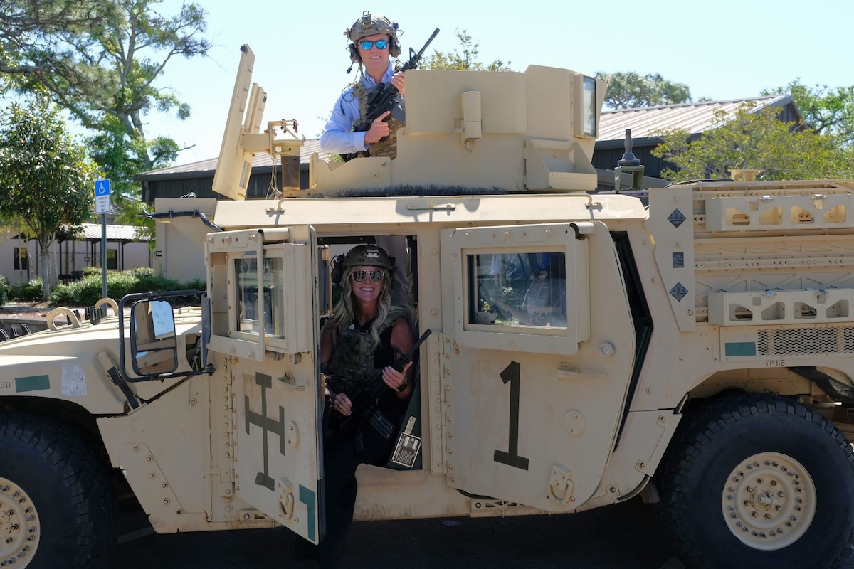 photo of two civic leaders in a humvee
