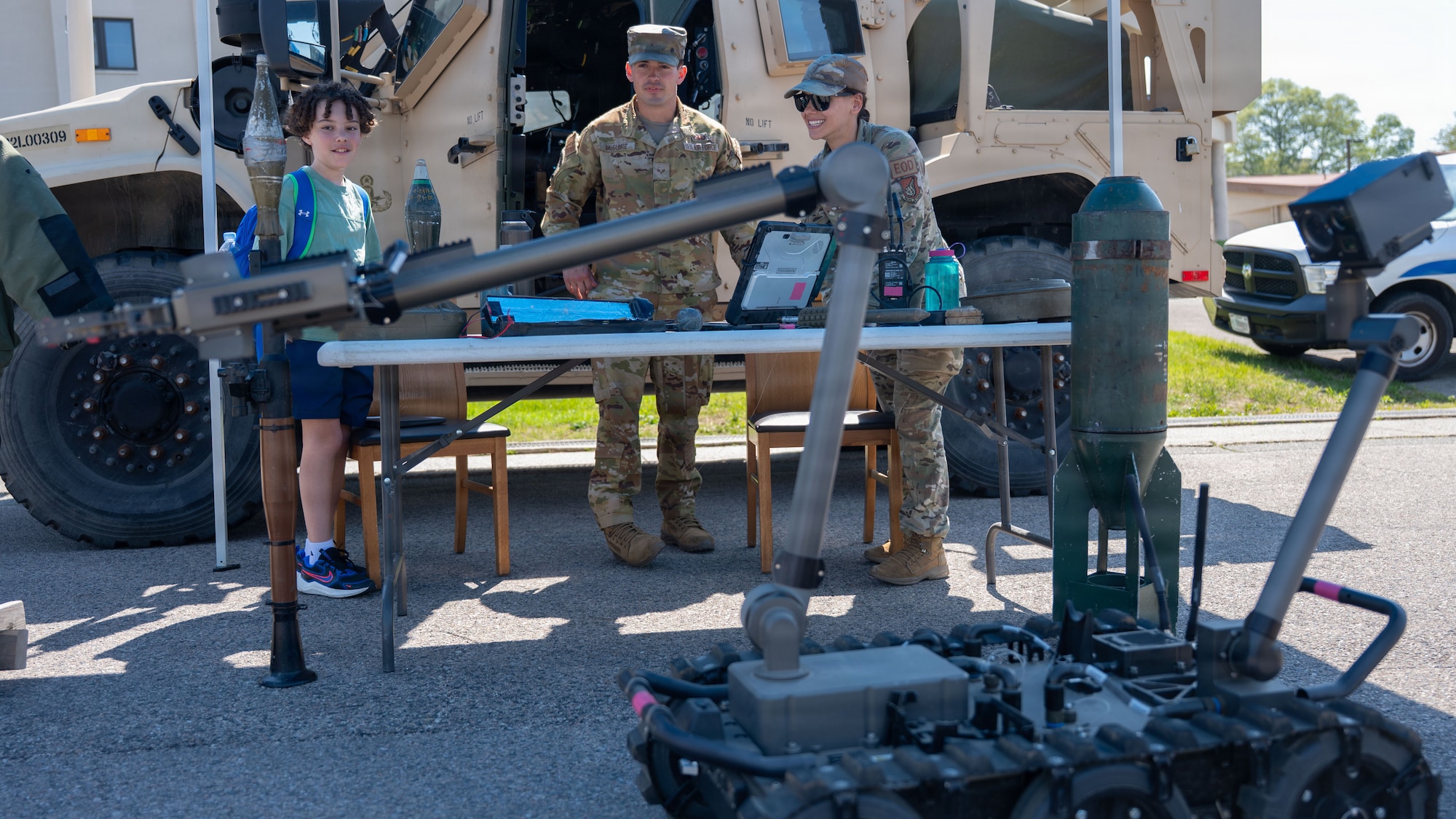 U.S. Airmen assigned to the 51st Civil Engineer Squadron watches as a child operates an Explosive Ordinance Disposal robot during Police Week at Osan Air Base, Republic of Korea, May 5, 2026. The displays highlighted the tools and resources Defenders use to support force protection and base defense operations. (U.S. Air Force photo by Senior Airman Rome Bowermaster)