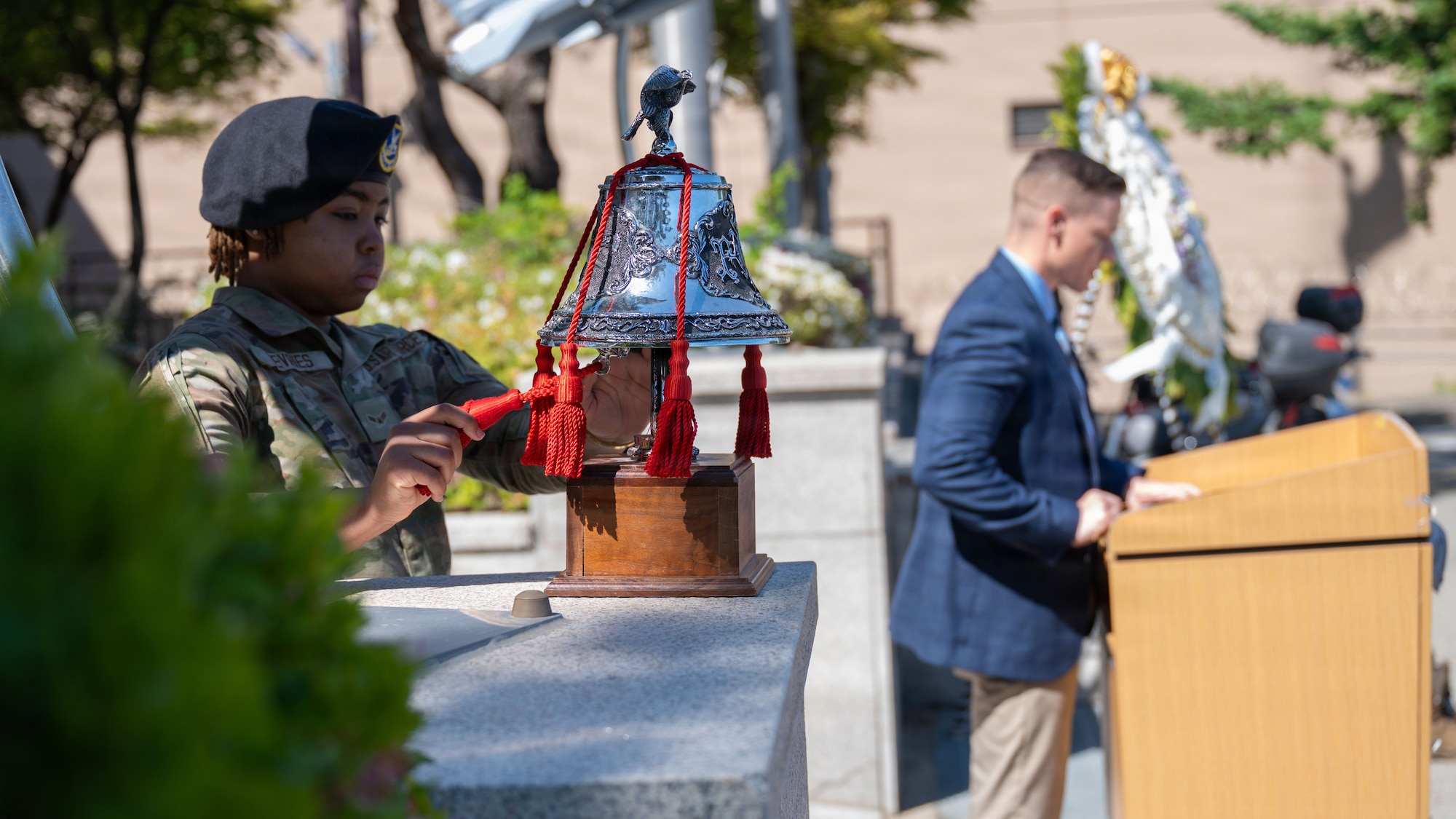 U.S. Airman 1st Class Shania DeVries, installation entry controller, rings the memorial bell during a closing ceremony at Osan Air Base, Republic of Korea, May 8, 2026. The ceremony concluded Police Week, reinforcing the importance of honoring those who have made the ultimate sacrifice in the line of duty. (U.S. Air Force photo by Senior Airman Rome Bowermaster)