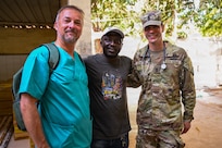 Austrian Army Col. Christian Schützenhöfer, a dentist, and U.S. Army Sgt. 1st Class Tim Farrow, a flight medic with the Vermont Army National Guard, pose with a Senegalese patient following a dental extraction during a multinational medical readiness exercise, or MEDREX, in Ziguinchor, Senegal, May 6, 2026.