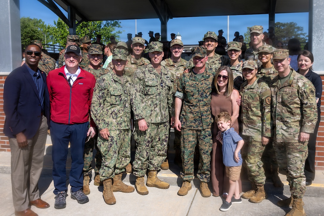 U.S. service members and civilians pose for a photo to celebrate a change of command ceremony on Marine Corps Base Camp Lejeune, North Carolina, April 17, 2025. Lt. Col. Adam S. Young relinquished command to Lt. Col. Rob K. Livengood, the incoming commanding officer of 2nd Bn, 2nd Marines, formally transferring authority and responsibility. (U.S. Marine Corps photo by Lance Cpl. Preston Morris)
