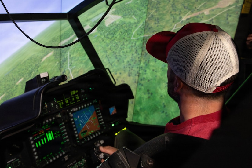 A man operates an aircraft simulator.