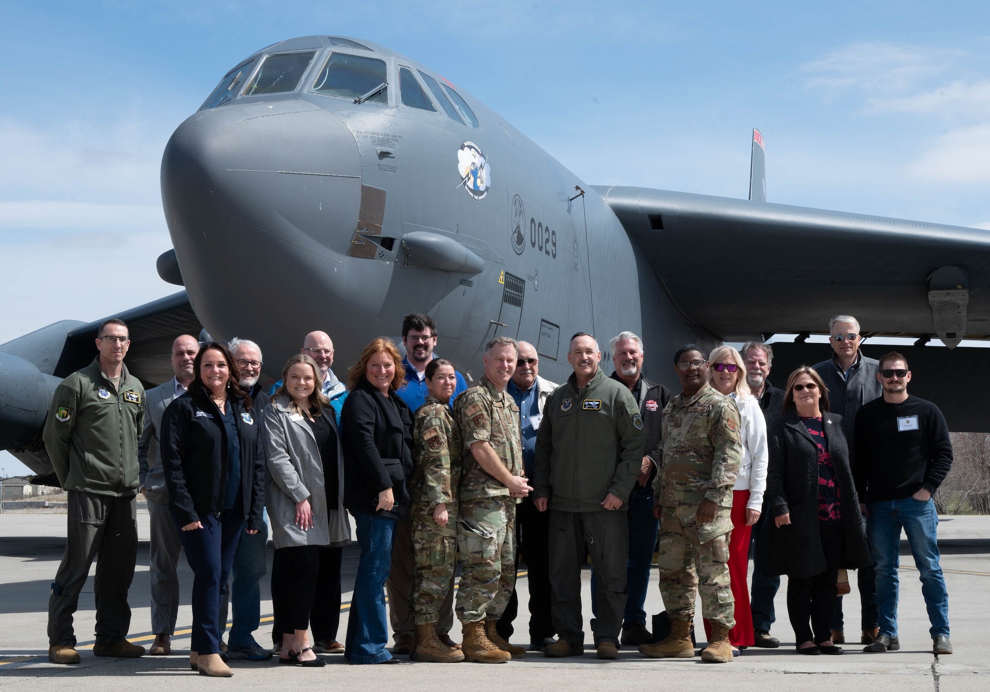 Distinguished visitors and base leadership pose for a group picture in front of a B-52H Stratofortress.