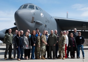Distinguished visitors and base leadership pose for a group picture in front of a B-52H Stratofortress.