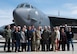 Distinguished visitors and base leadership pose for a group picture in front of a B-52H Stratofortress.