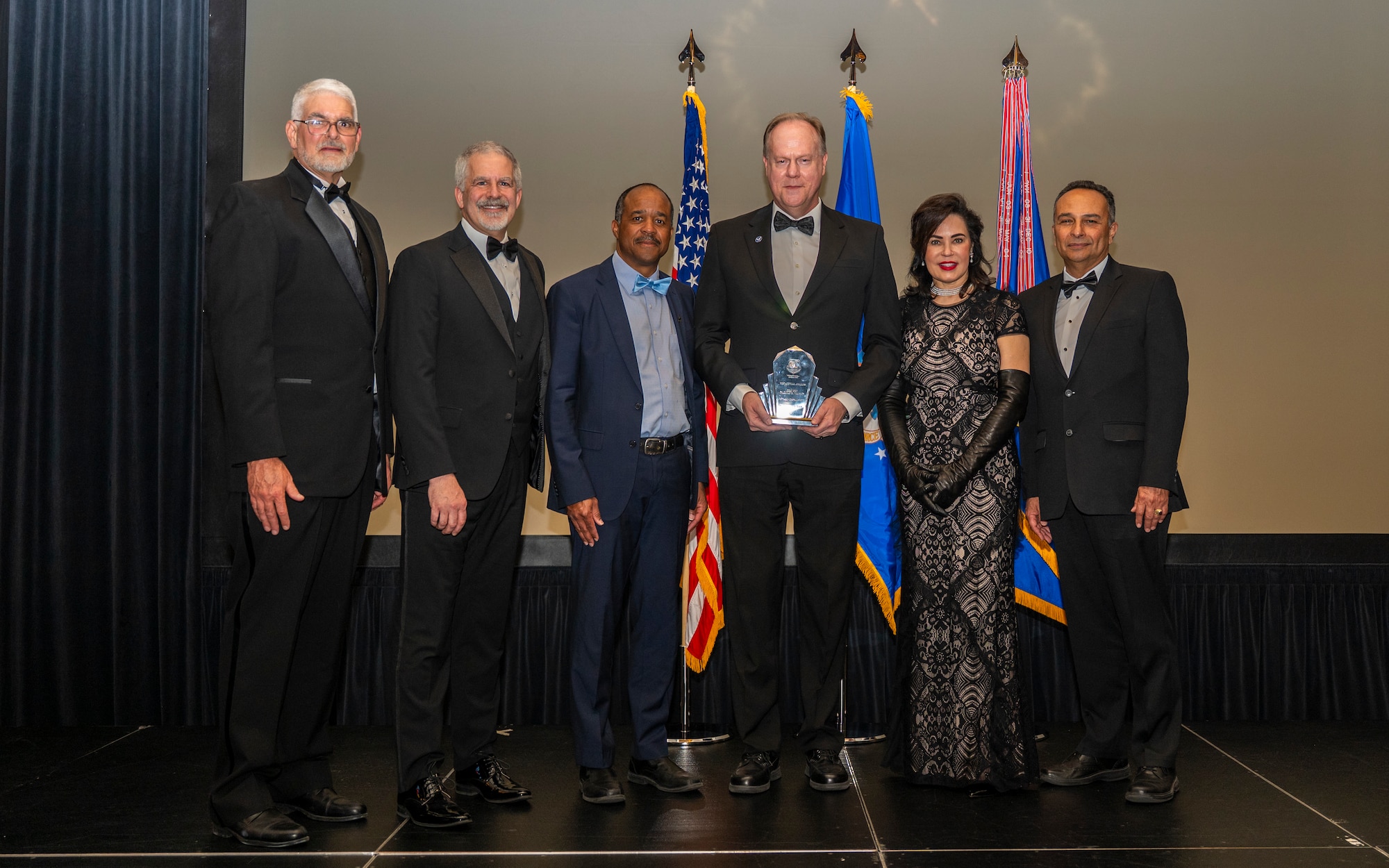 One of the newest recipients of the prestigious Harold E. Watson Award, Warren Synder, stands alongside previous National Air and Space Intelligence Center Watson Award winners.