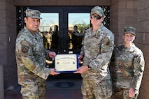 U.S. Airmen holding a certificate.