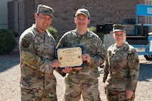 U.S. Airmen holding a certificate.