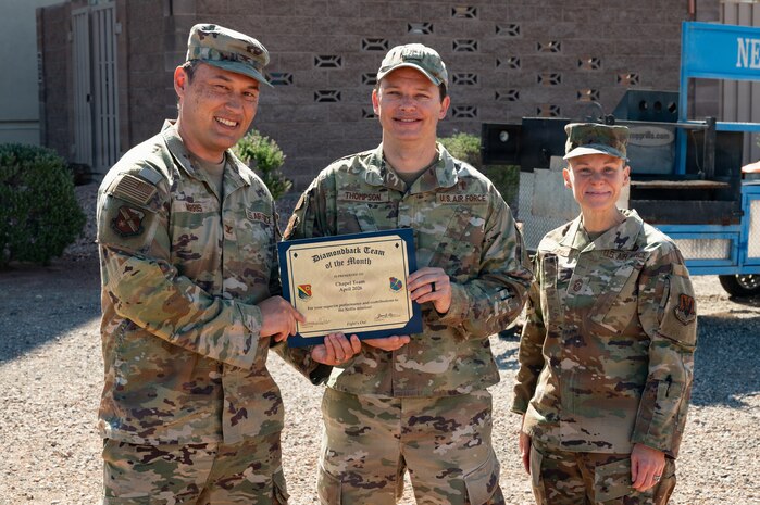 U.S. Airmen holding a certificate.