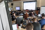 Participants of Cyber Yankee 2026 participate in a training exercise prior to the start of the practical exercise portion of the event at Camp Nett, Niantic, Connecticut, May 11, 2026. Cyber Yankee is the National Guard’s premier annual regional cyber training exercise, linking military cyber warriors with cyber experts from local utility companies to collaborate and train together on how to respond to credible cyber threats against critical infrastructure. Photo by Spc. Emmanuel Gibson.