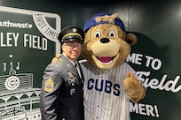 Sgt. 1st Class Moises Garcia, 85th U.S. Army Reserve Support Command, meets Clark, the Chicago Cubs’ mascot, after a military recognition during a Chicago Cubs MLB home game verses the Cincinnati Reds, May 5, 2026, at Wrigley Field.