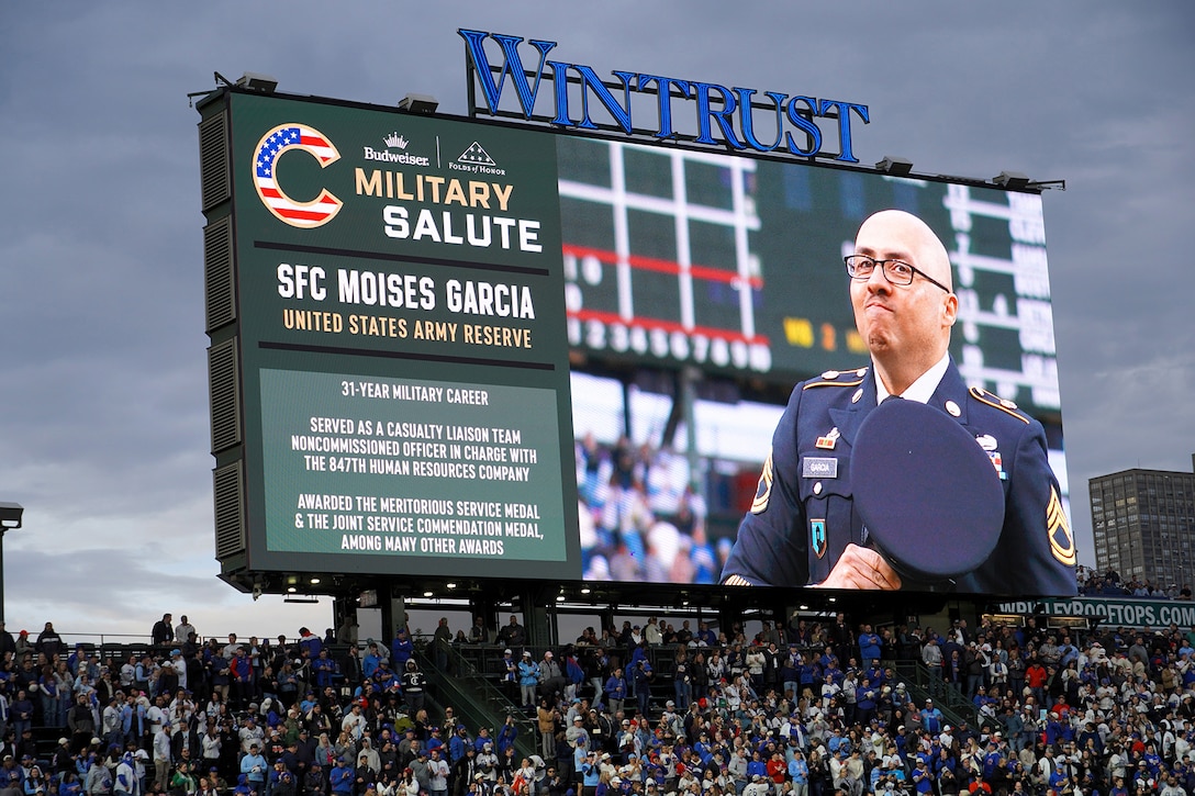 Sgt. 1st Class Moises Garcia, 85th U.S. Army Reserve Support Command, appears on the Wrigley Field jumbotron during a military salute at the Chicago Cubs home game, May 5, 2026, at Wrigley Field. Garcia was honored for his 31 years of service, including five overseas deployments.