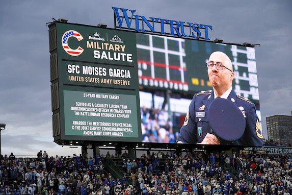 Sgt. 1st Class Moises Garcia, 85th U.S. Army Reserve Support Command, appears on the Wrigley Field jumbotron during a military salute at the Chicago Cubs home game, May 5, 2026, at Wrigley Field. Garcia was honored for his 31 years of service, including five overseas deployments.