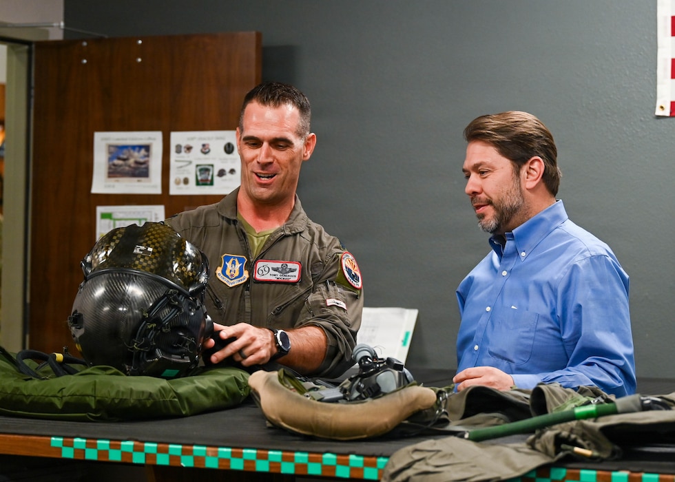 A U.S. Air Force F-35A Lightning II pilot shows Sen. Ruben Gallego flight equipment during a tour at Luke Air Force Base, Arizona, May 7, 2026. The visit emphasized the importance of community engagement and highlighted Luke AFB’s readiness and innovation for the Airmen who will dominate tomorrow’s fight. (U.S. Air Force photo by Airman 1st Class Rebecca Wagner)