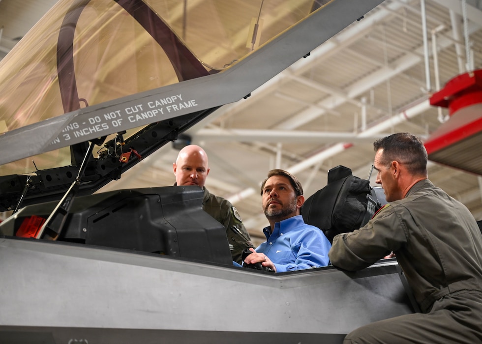 U.S. Air Force Brig. Gen. David Berkland, 56th Fighter Wing commander, left, and a U.S. Air Force F-35A Lightning II pilot speak with Sen. Ruben Gallego, center, inside an aircraft cockpit at Luke Air Force Base, Arizona, May 7, 2026. Visits with community and government leaders strengthen partnerships and demonstrate Luke AFB’s role in delivering disciplined and integrated combat-ready airpower in the global theater. (U.S. Air Force photo by Airman 1st Class Rebecca Wagner)