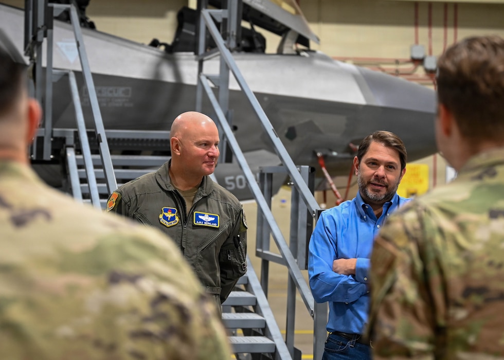 U.S. Air Force Brig. Gen. David Berkland, 56th Fighter Wing commander, left, and Sen. Ruben Gallego, right, speak with Airmen during a visit to Luke Air Force Base, Arizona, May 7, 2026. Gallego’s visit highlighted the importance of community and stakeholder partnerships and showcased Luke AFB’s culture of teamwork and combat-ready mission transparency. (U.S. Air Force photo by Airman 1st Class Rebecca Wagner)