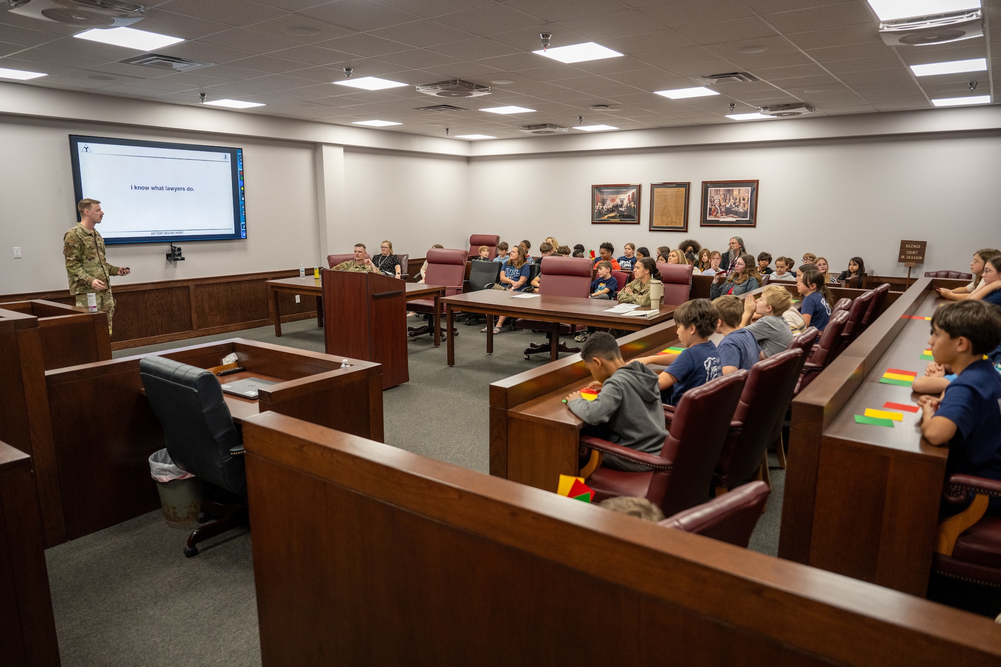 Students from Mendel L. Rivers Elementary School receive a briefing on the basics of law at Altus Air Force Base, Oklahoma, May 1, 2026. The briefing was part of a Law Day event hosted by the 97th Air Mobility Wing Judge Advocate office, giving students an opportunity to engage with military legal professionals and learn about the civilian and military justice systems. (U.S. Air Force photo by Airman 1st Class Nathan Langston)