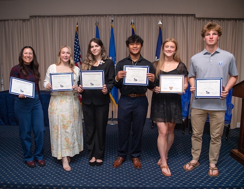 image of people holding their certificates after a ceremony.