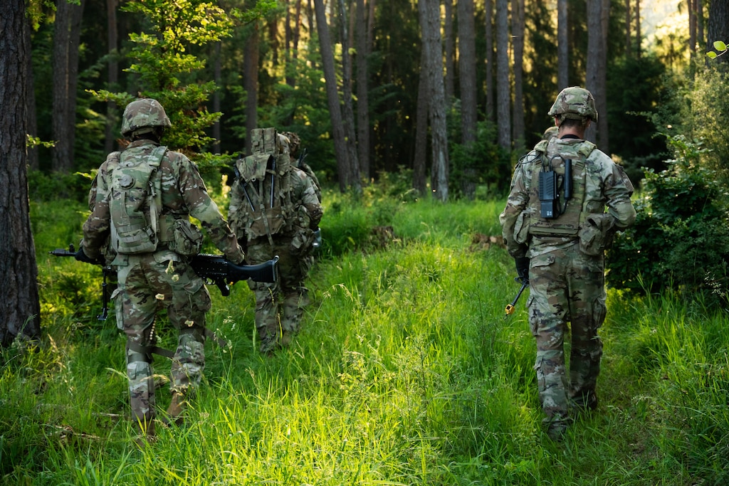 Soldiers walking in the woods.