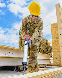 Interior electrician Pfc. Kyra Folks, assigned to Wyoming Army National Guard’s 307th Engineer Utilities Detachment, operates a caulking gun during a two-week Innovative Readiness Training project providing military engineer training while helping construct homes for local residents in Cheyenne, Wyoming, May 9, 2026.