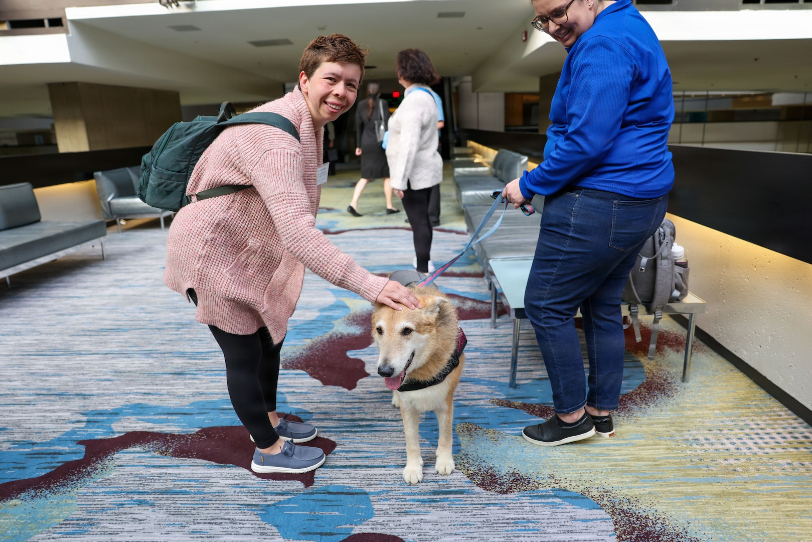 A family member pets Annie, from Love on a Leash, a therapy dog organization that provides certified therapy dogs for veterans and others in need, during the Defense POW/MIA Accounting Agency Family Member Update in Detroit, Mi., May 2, 2026.