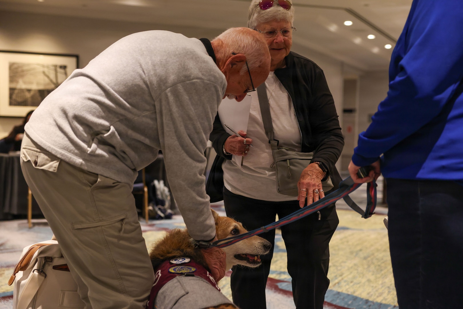 A family member pets Annie, from Love on a Leash, a therapy dog organization that provides certified therapy dogs for veterans and others in need, during the Defense POW/MIA Accounting Agency Family Member Update in Detroit, Mi., May 2, 2026.