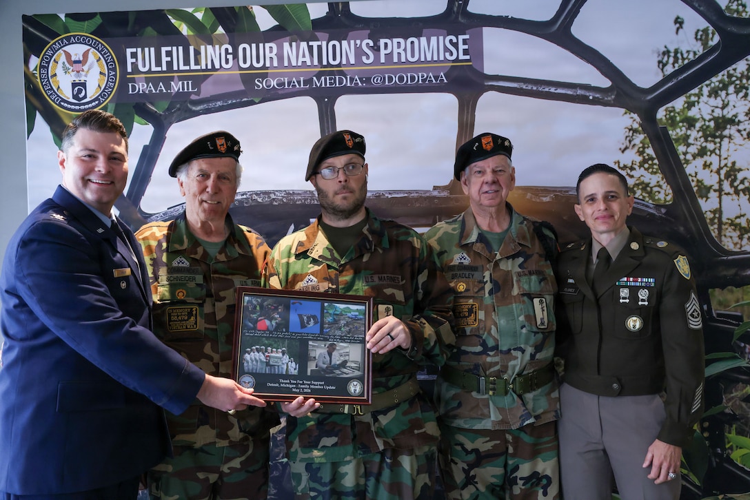U.S. Air Force Col. Derek Rankin, chief of staff for the Defense POW/MIA Accounting Agency and U.S. Army Sgt. Maj. Lauren Flores, the DPAA senior enlisted advisor pose for a photo with Vietnam Veterans of America Chapter 154 during a Family Member Update in Detroit, Mi., May 2, 2026.