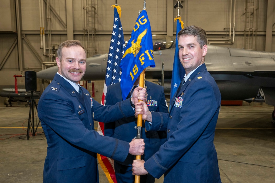 U.S. Air Force Maj. Harrison Gebs, right, assumes command of the 18th Fighter Interceptor Squadron from U.S. Air Force Col. Samuel Chipman, 354th Operations Group commander, during a change of command ceremony at Eielson Air Force Base, Alaska, May 8, 2026.