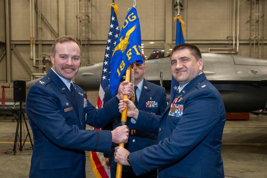 U.S. Air Force Lt. Col. Nathan Mondul, right, relinquishes command of the 18th Fighter Interceptor Squadron to U.S. Air Force Col. Samuel Chipman, 354th Operations Group commander, during a change of command ceremony at Eielson Air Force Base, Alaska, May 8, 2026.