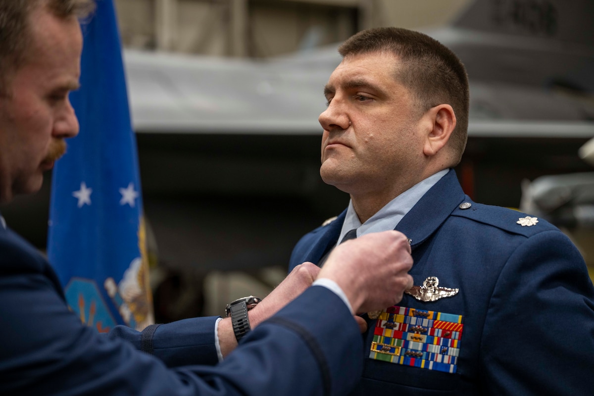 U.S. Air Force Lt. Col. Nathan Mondul, 18th Fighter Interceptor Squadron commander, right, receives the Meritorious Service Medal from U.S. Air Force Col. Samuel Chipman, 354th Operations Group commander, during a change of command ceremony at Eielson Air Force Base, Alaska, May 8, 2026.