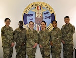 Members of the Continuous Medical Readiness (CMR) Cell at David Grant USAF Medical Center pose for a group photo at Travis Air Force Base, Calif., April 7, 2026. The CMR Cell supports medical readiness operations by coordinating deployment-related medical requirements and guiding Airmen through a streamlined readiness process. Capt. Isabella M. Cordova, officer in charge of the CMR Cell, is pictured fifth from left.
