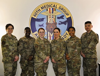 Members of the Continuous Medical Readiness (CMR) Cell at David Grant USAF Medical Center pose for a group photo at Travis Air Force Base, Calif., April 7, 2026. The CMR Cell supports medical readiness operations by coordinating deployment-related medical requirements and guiding Airmen through a streamlined readiness process. Capt. Isabella M. Cordova, officer in charge of the CMR Cell, is pictured fifth from left.