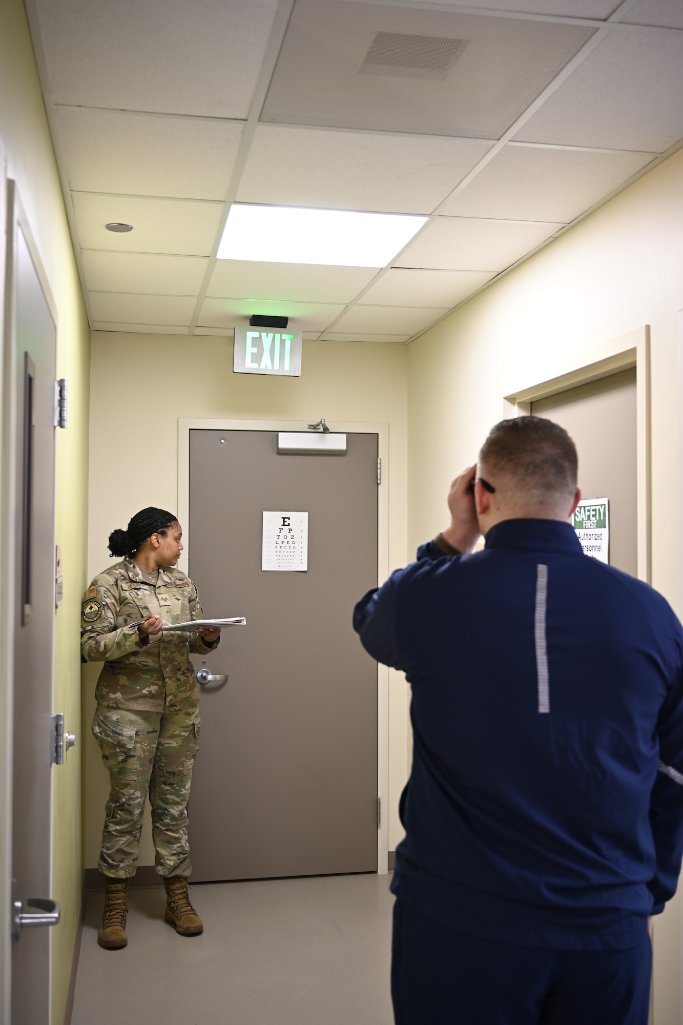 An Airman assigned to the 60th Medical Group directs fellow Airmen at a readiness processing station at David Grant USAF Medical Center, Travis Air Force Base, Calif., March 23, 2026. The Continuous Medical Readiness model centralizes medical readiness actions into a single-day process, designed to improve efficiency and support operational readiness.
